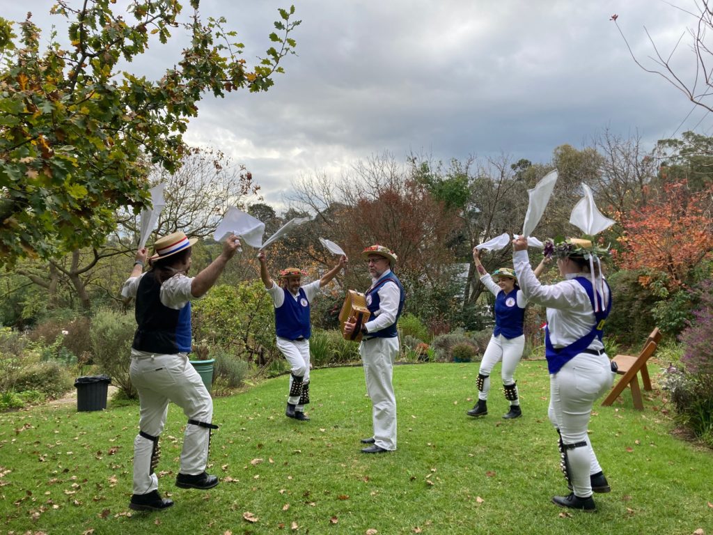 Four Britannia dancers dancing in the grass